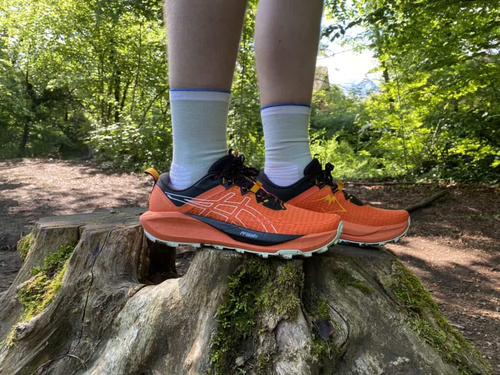 photo of the asics trabuco 13 in orange from the side